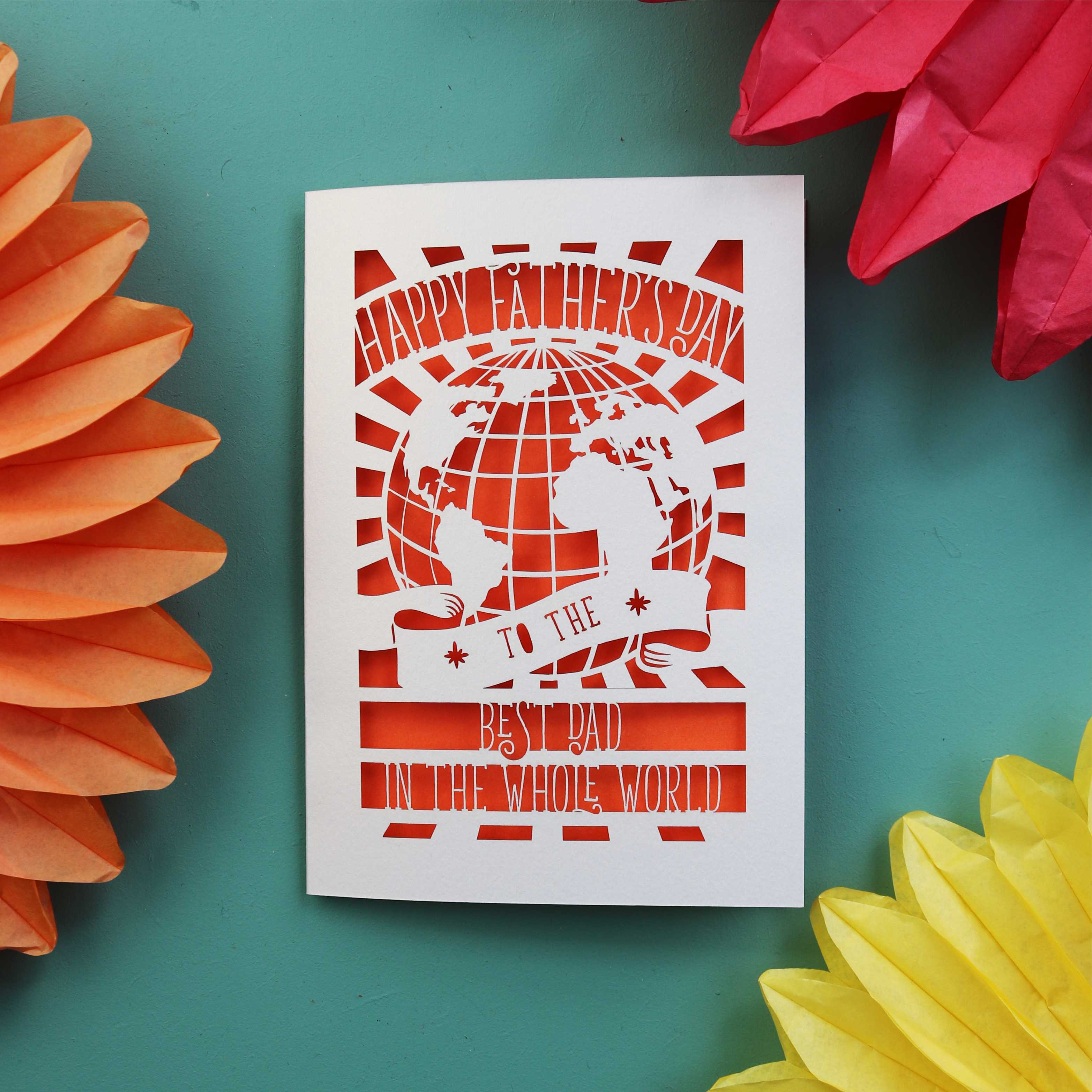 A unusual Father's Day card made in the UK with a cut out of the world and the words "Happy Fathers Day to the best dad in the whole world"