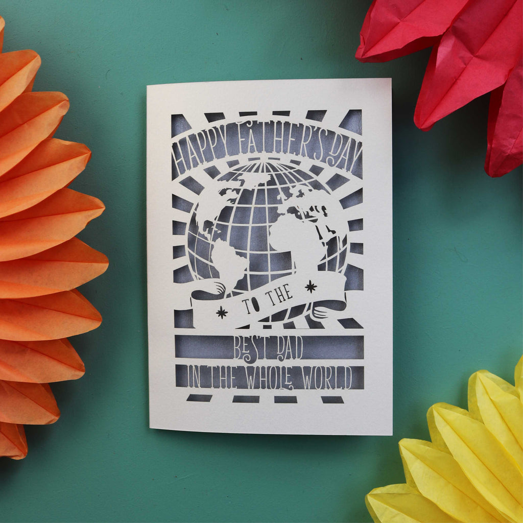 UK made fathers day cards with a cut out of the world and the words "Happy Fathers Day to the best dad in the whole world"