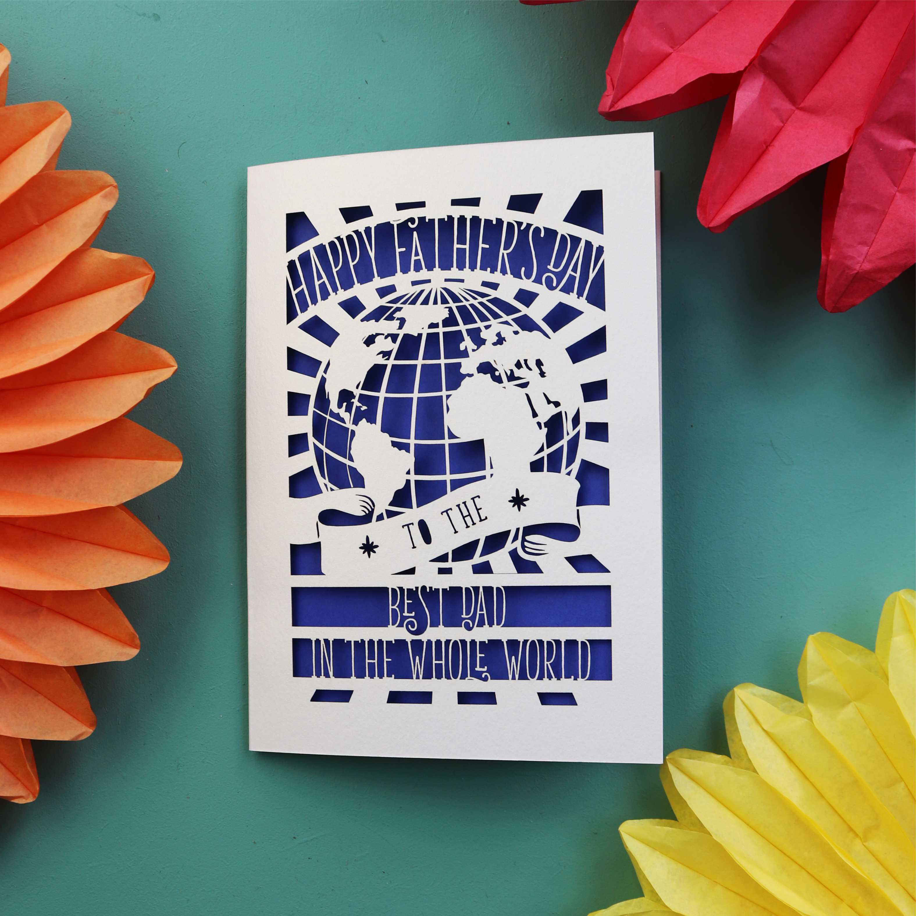 A keepsake Father's Day card from the UK, with a cut out of the world and the words "Happy Fathers Day to the best dad in the whole world"