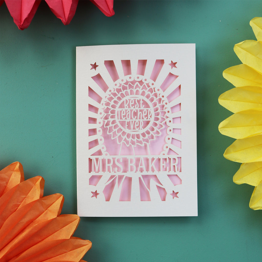 A cream and candy pink personalised thank you teacher card with a rosette for the best teacher ever