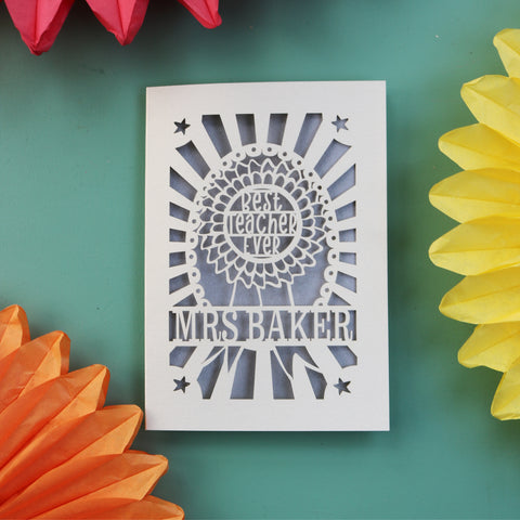 A thank you card for teachers. This card features a rosette and is personalised with the teacher's name - A6 / Silver