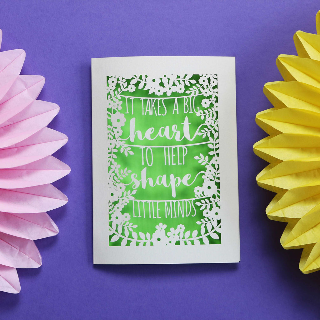 A laser cut teacher card in cream with a green paper insert. 