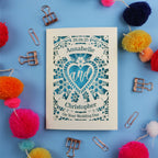 Personalized laser cut wedding card with decorative elements on a blue background
