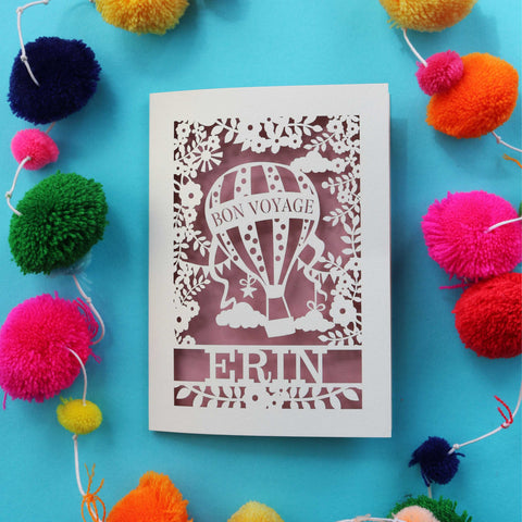 A laser cut card for someone going travelling. Card has a hot air balloon and the words "Bon Voyage" personalised with a name - A5 (large) / Dusky Pink