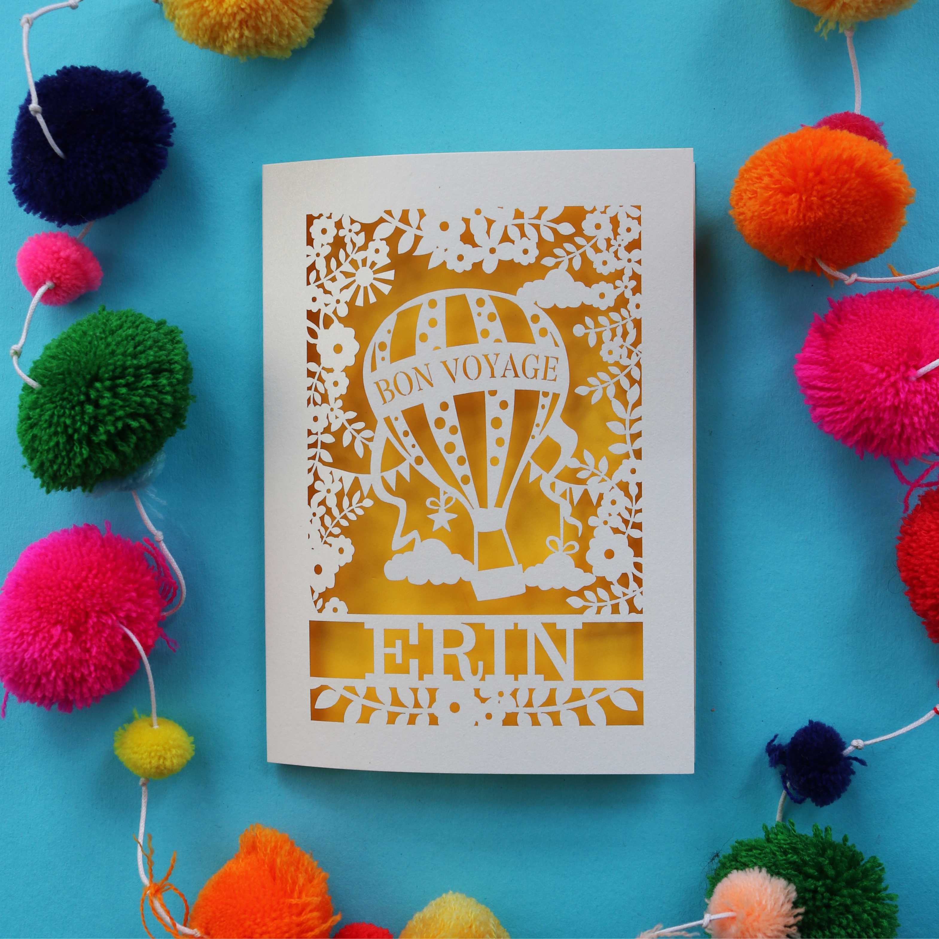 A cream and bright yellow laser cut personalised bon voyage card