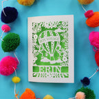 A cream and bright green laser cut bon voyage card