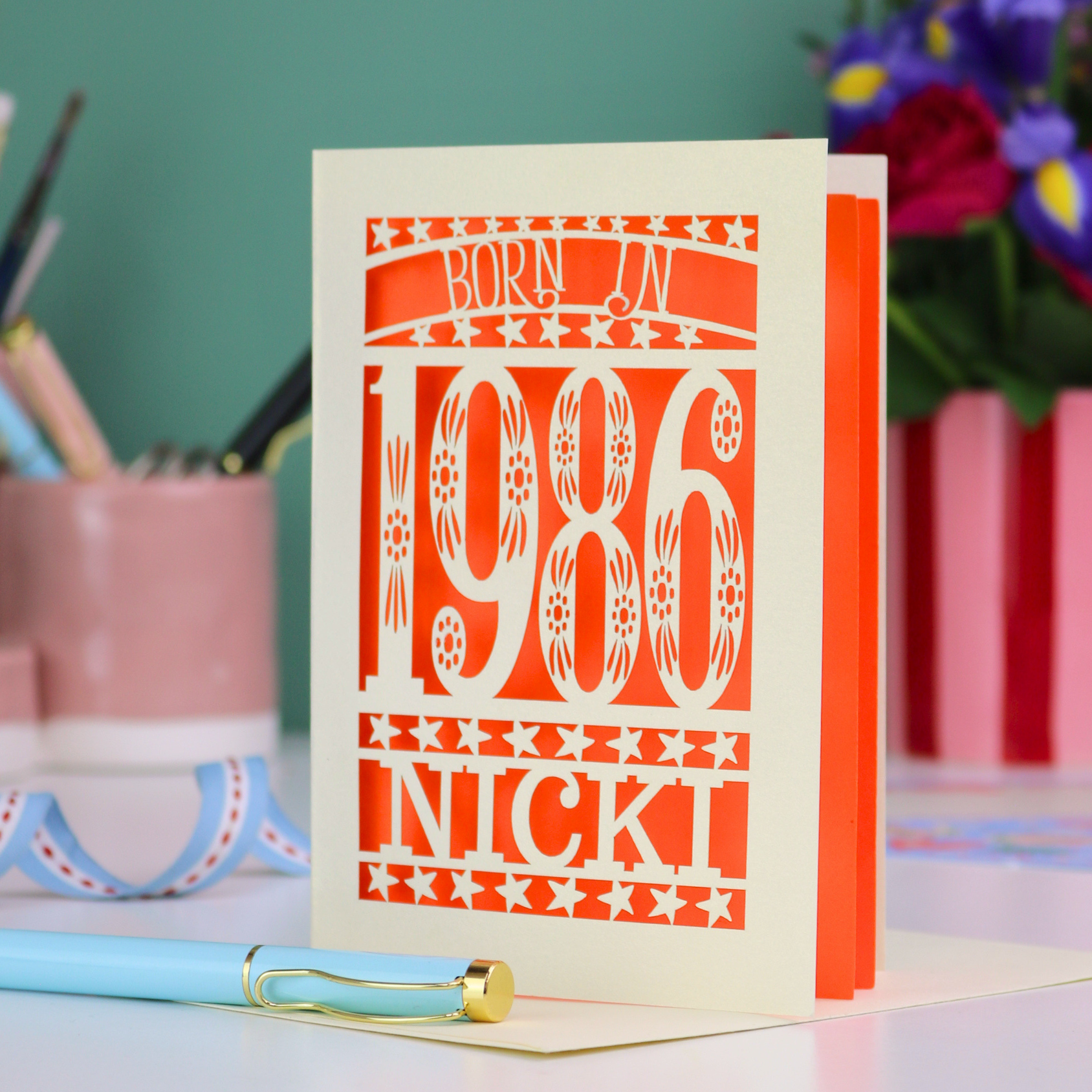 Greeting card with 'Born in 1986 Nicki' text on a colorful background