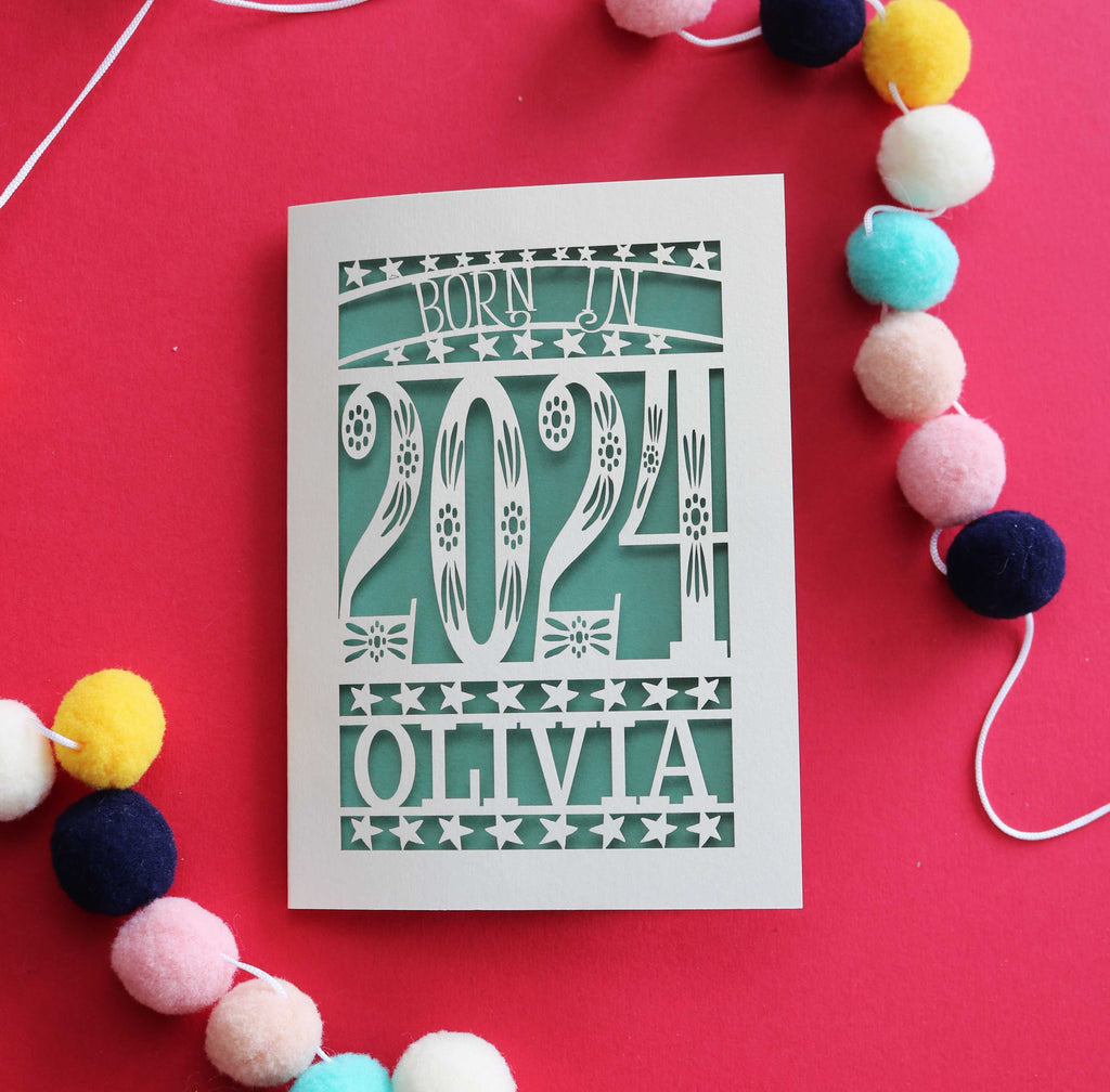 A laser cut baby card that says "Born in 2024"