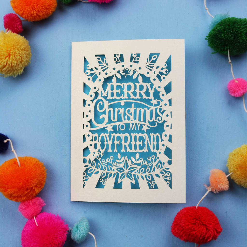 Keepsake Boyfriend Christmas card with 'Merry Christmas to my boyfriend' text on a blue background with colourful pom-poms.