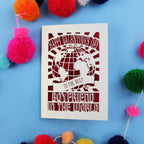 Laser cut boyfriend Valentine's Card with 'Happy Valentine's Day to the best boyfriend in the world' text on a blue background with colourful pom-poms.