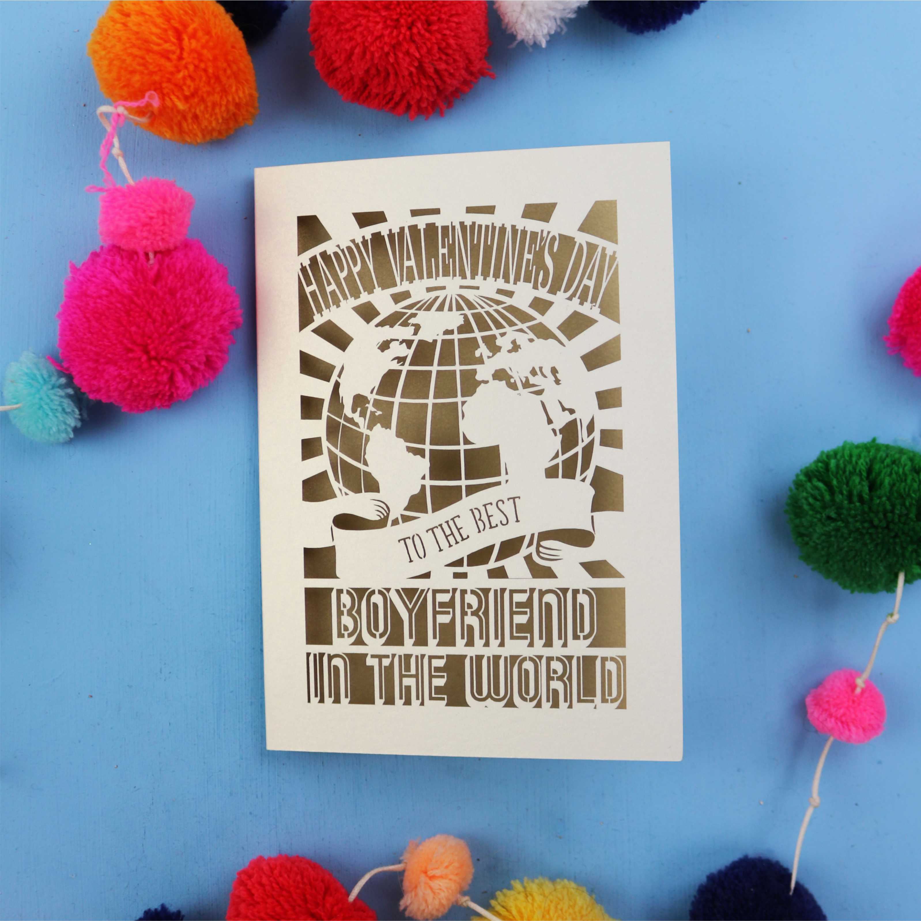 Cute boyfriend Valentines Card with 'Happy Valentine's Day to the best boyfriend in the world' text on a blue background with colourful pom-poms.