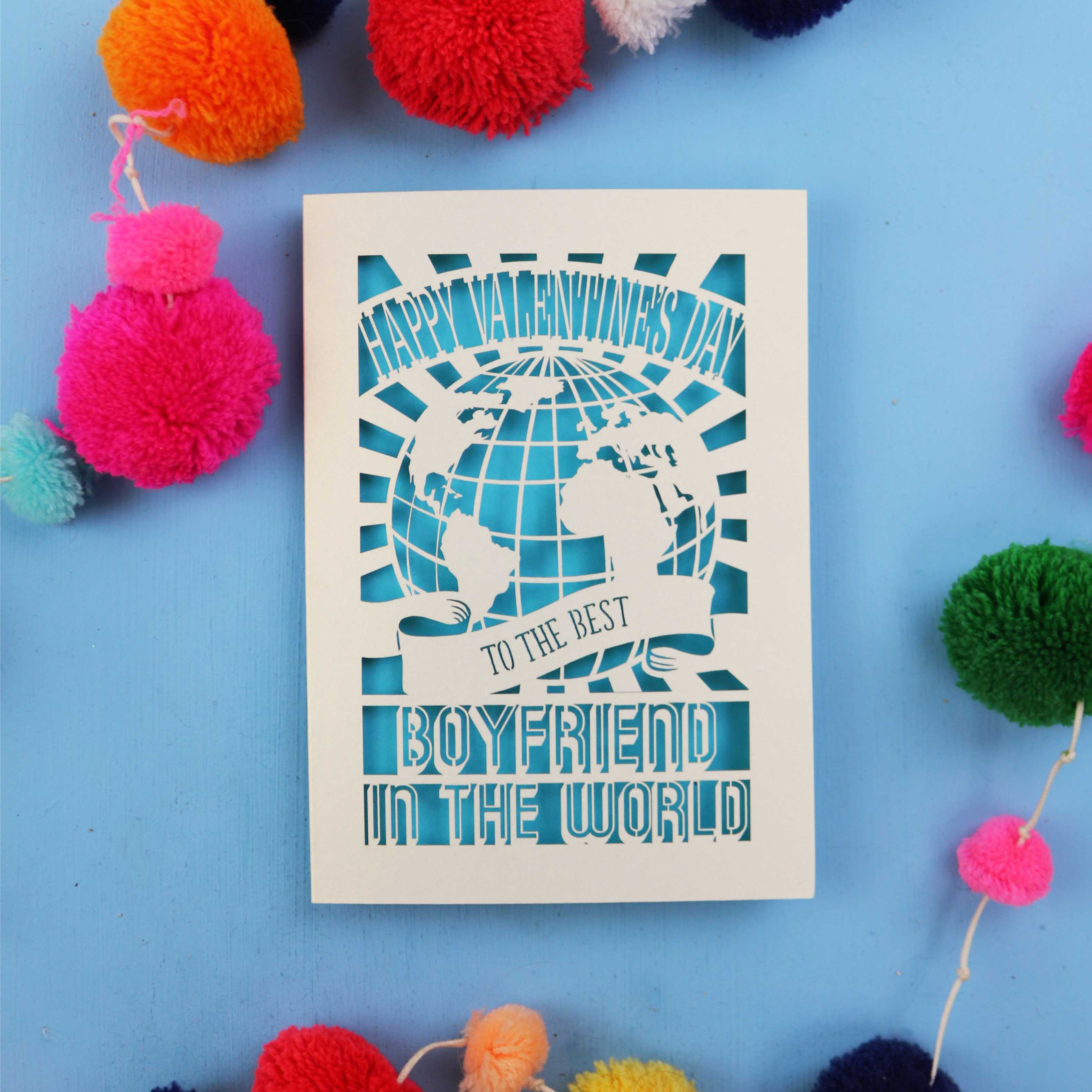 Cut out boyfriend Valentines Card with 'Happy Valentine's Day to the best boyfriend in the world' text on a blue background with colourful pom-poms.