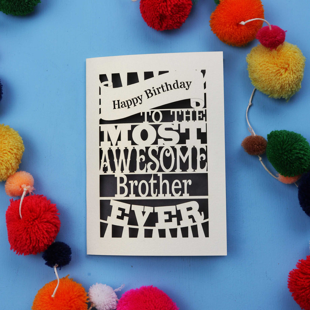 Handmade brother Birthday card for the most awesome brother ever on a blue background with colourful pom-poms.