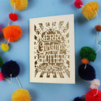 Brother Christmas card with 'Merry Christmas to my brother' text on a blue background with colourful pom-poms.