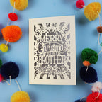 Brother Christmas card with 'Merry Christmas to my brother' text on a blue background with colourful pom-poms.