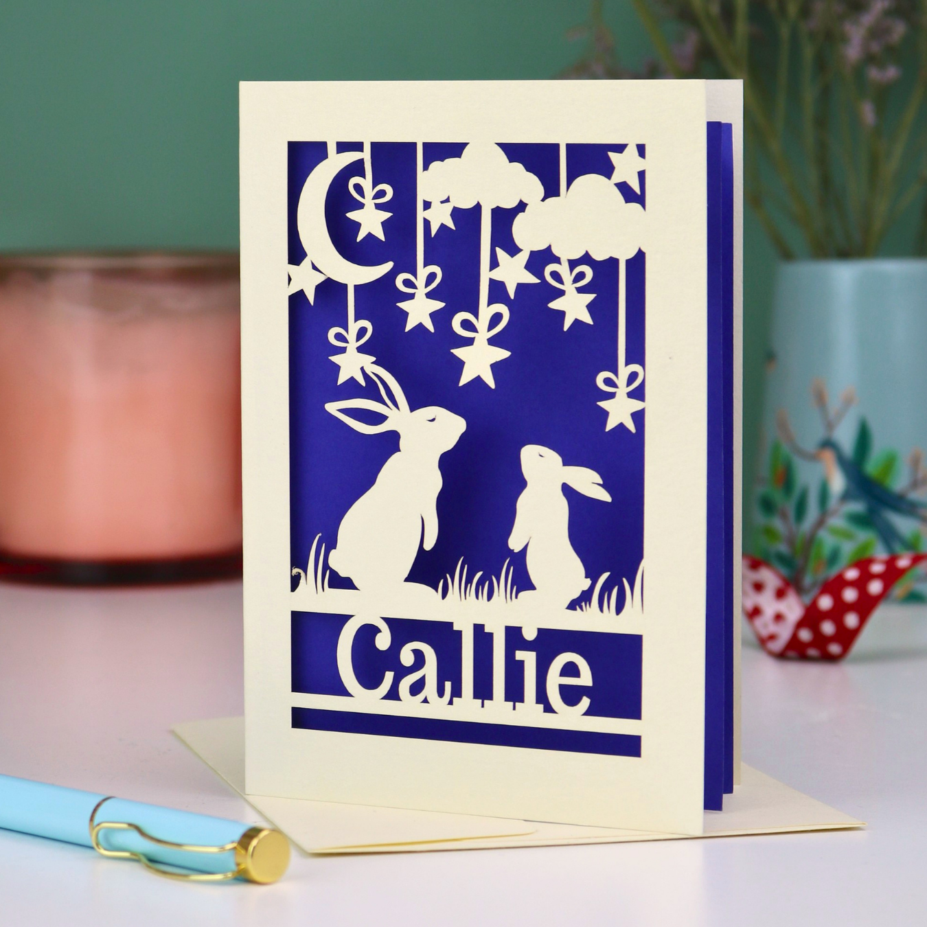 Birthday card with cut-out rabbit design and 'Callie' text on a blue background