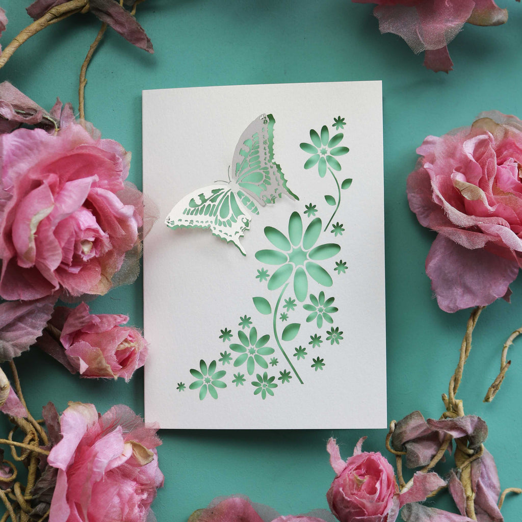 A paper cut butterfly and flowers card