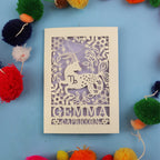 Decorative birthday card with Capricorn zodiac symbol on a blue background with colourful pom-poms.