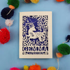 Decorative birthday card with Capricorn zodiac symbol on a blue background with colourful pom-poms.