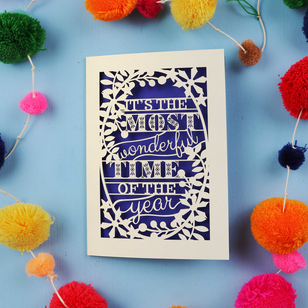 Decorative laser cut Christmas card with 'It's the most wonderful time of the year' text 