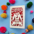 Unique Christmas card with festive Christmas jumper design on a blue background with colourful pom-poms.