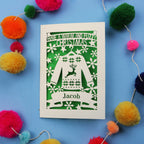 Unique Christmas card with festive Christmas jumper design on a blue background with colourful pom-poms.
