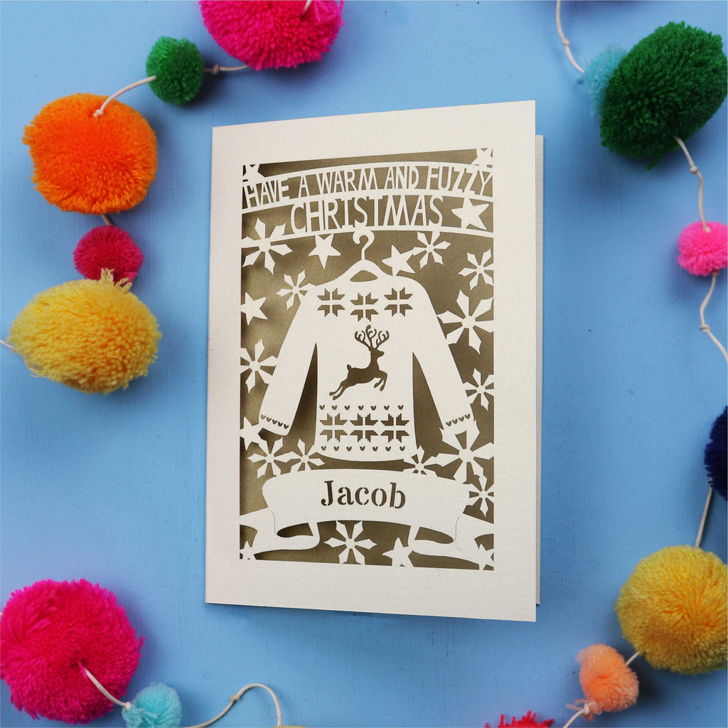 Unique Christmas card with festive Christmas jumper design on a blue background with colourful pom-poms.