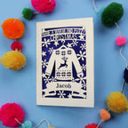 Unique Christmas card with festive Christmas jumper design on a blue background with colourful pom-poms.