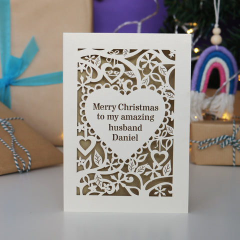 A personalised card for Christmas. Card has text inside a heart shape, with a border of hearts, flowers and snowflakes. - A5 / Cream / Gold Leaf