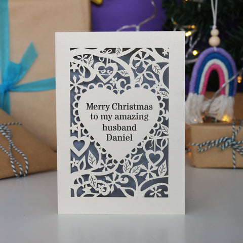 Laser cut Christmas cards. Image shows a cut out card with text inside a heart, surrounded by flowers and snowflakes. - A5 / Cream / Silver