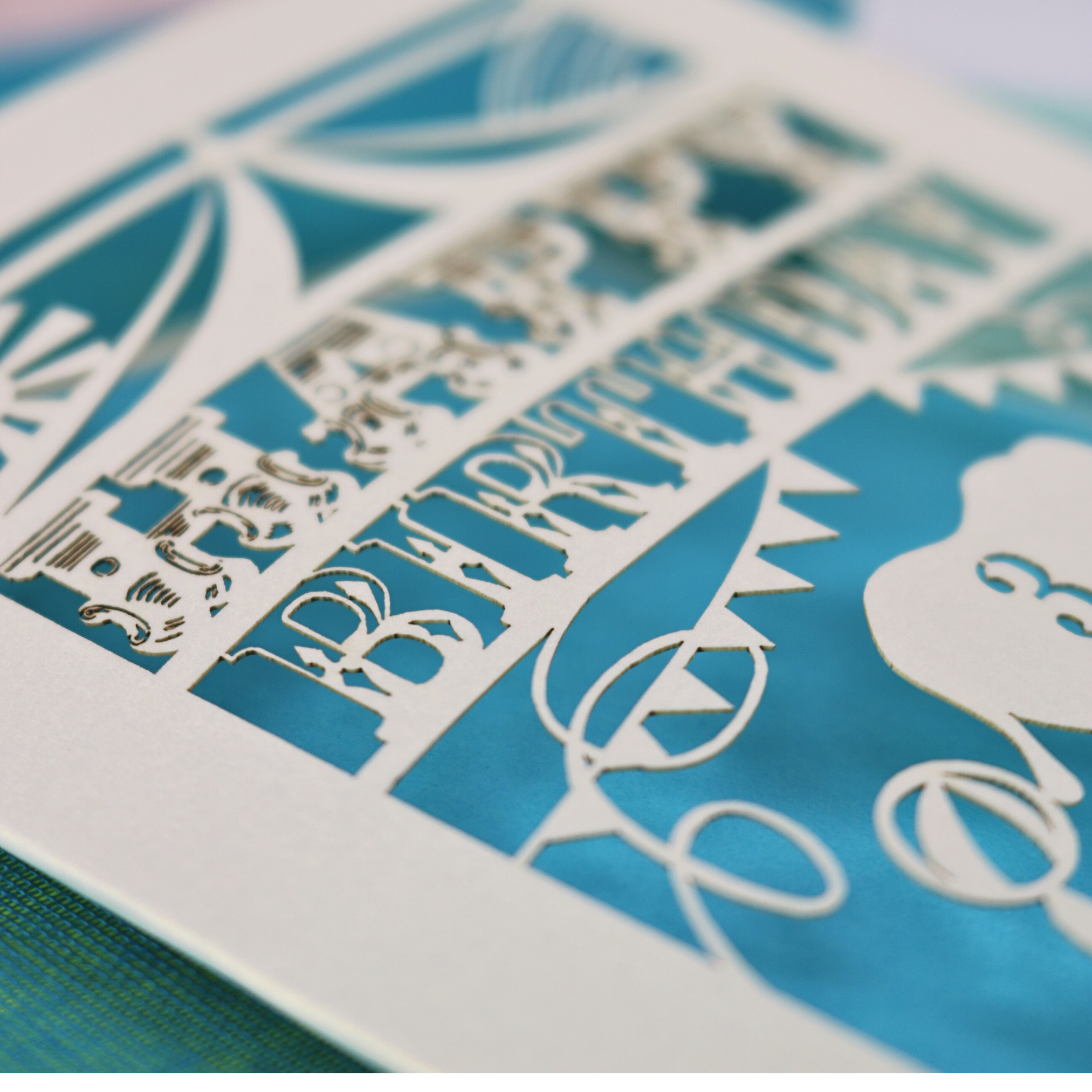 A laser cut birthday card with circus big top design, "Happy Birthday" and a name, with an age cut out.