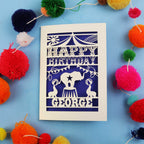 Fun Circus Birthday card with 'Happy Birthday George' text on a blue background with colourful pom-poms.