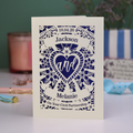 Personalized card with laser cut design and text on a table with decorative items.