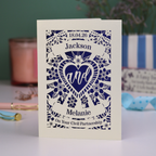 Personalized card with laser cut design and text on a table with decorative items.