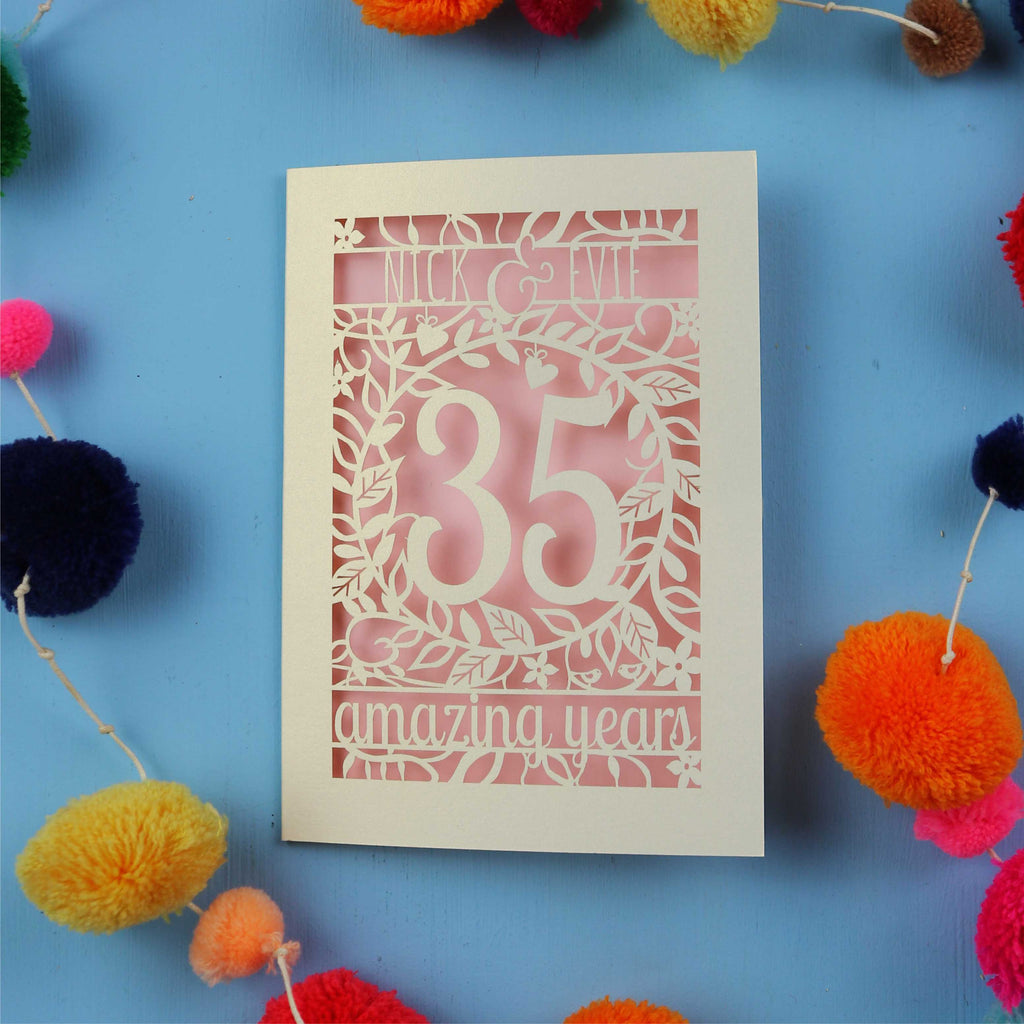 Coral wedding anniversary Card with '35 amazing years' on a blue background with colourful pom-poms