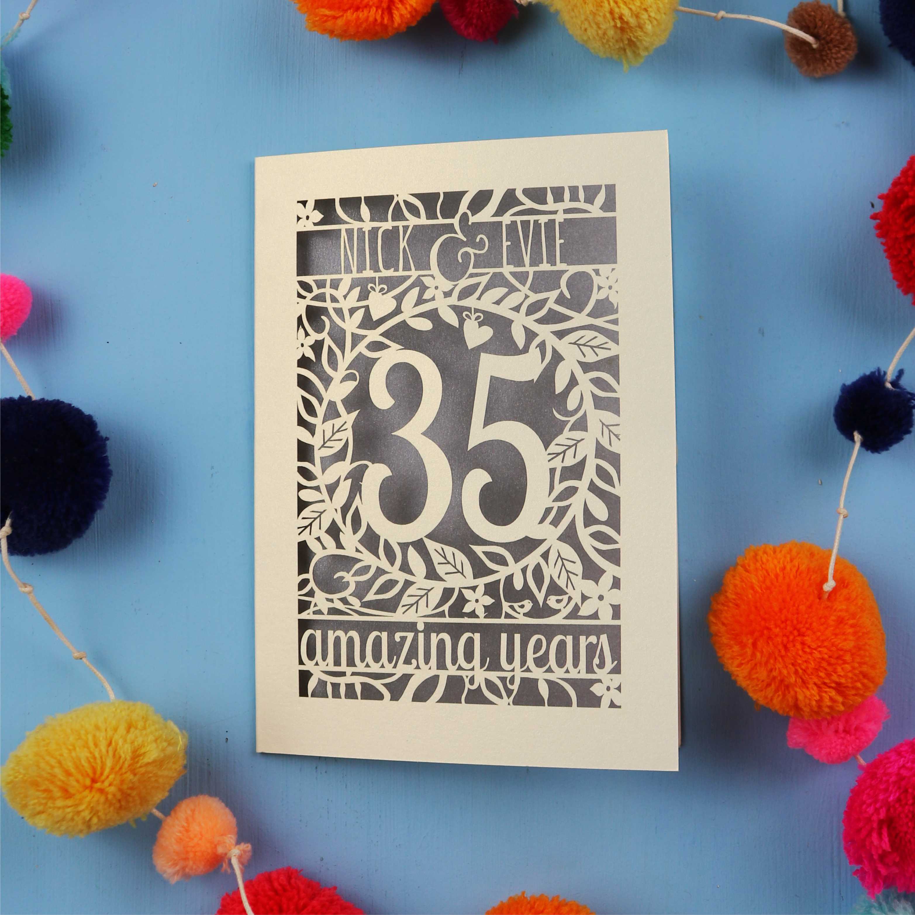 Coral 35th anniversary Card with '35 amazing years' on a blue background with colourful pom-poms
