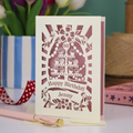 A cream and dusky pink laser cut 60th birthday card with cupcakes on a cake stand design, the number '60' and "Happy Birthday Jenny" personalised text in cut out stencil lettering