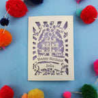 Personalized birthday card with decorative elements on a blue background with colourful pom-poms.