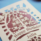 Laser-cut birthday card with decorative elements and 'Happy Birthday Julia' text on a blue background.