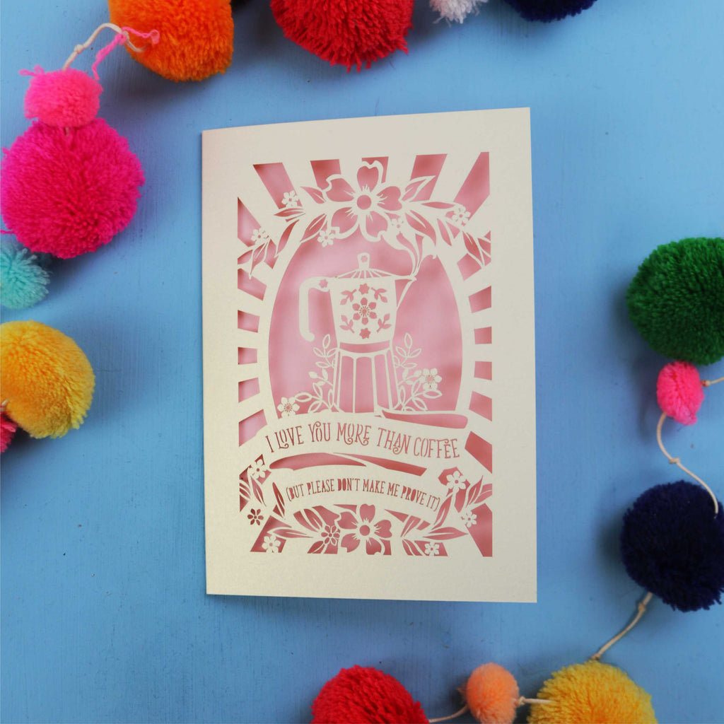 Laser cut funny Valentine's card with coffee-themed design on a blue background with colourful pom-poms.