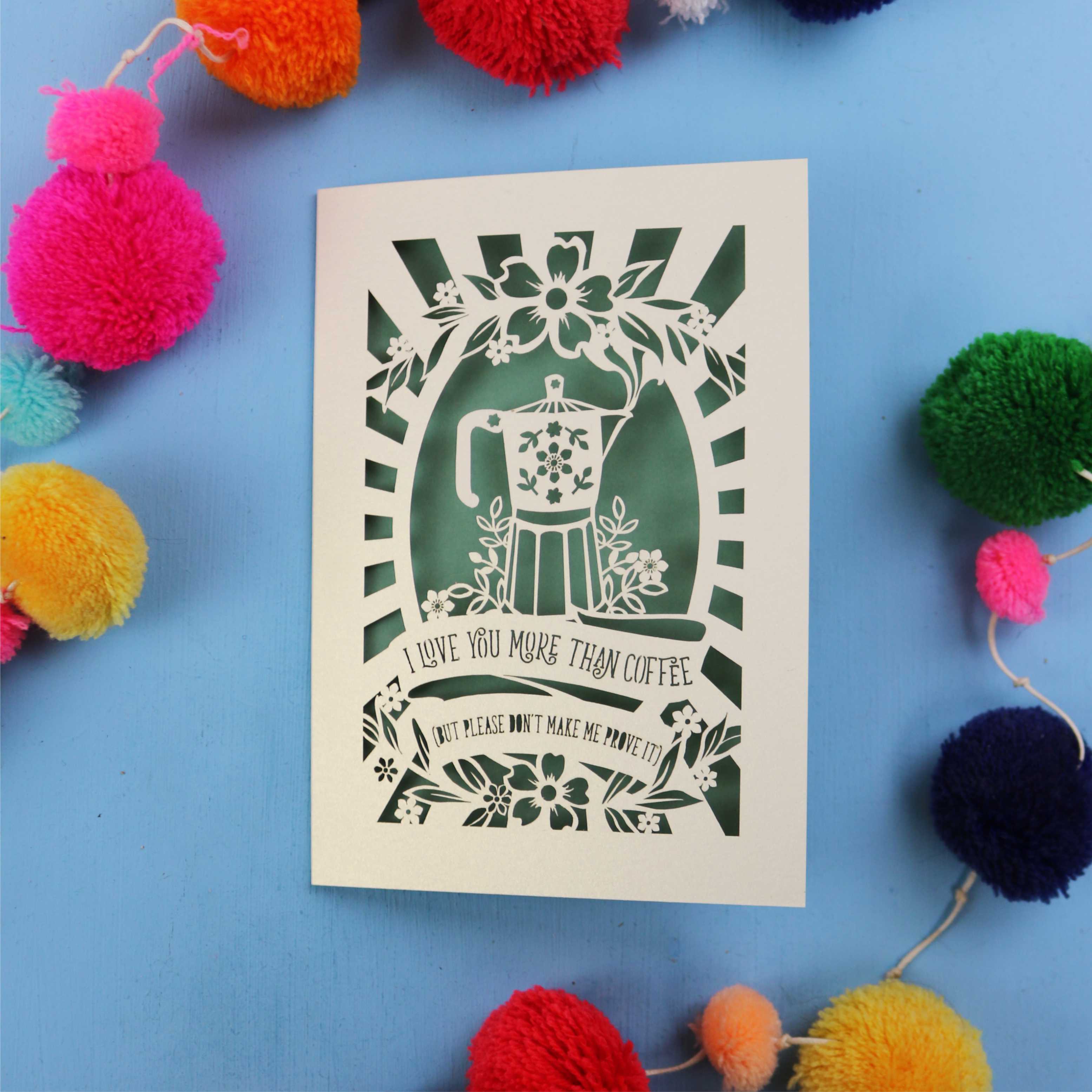 Decorative funny Valentine's card with coffee-themed design on a blue background with colourful pom-poms.