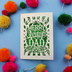 Dad Christmas card with 'Merry Christmas to my Dad' text on a blue background with colourful pom-poms.