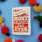 A Dad Birthday card for the most awesome dad ever with colourful pom-poms on a blue background