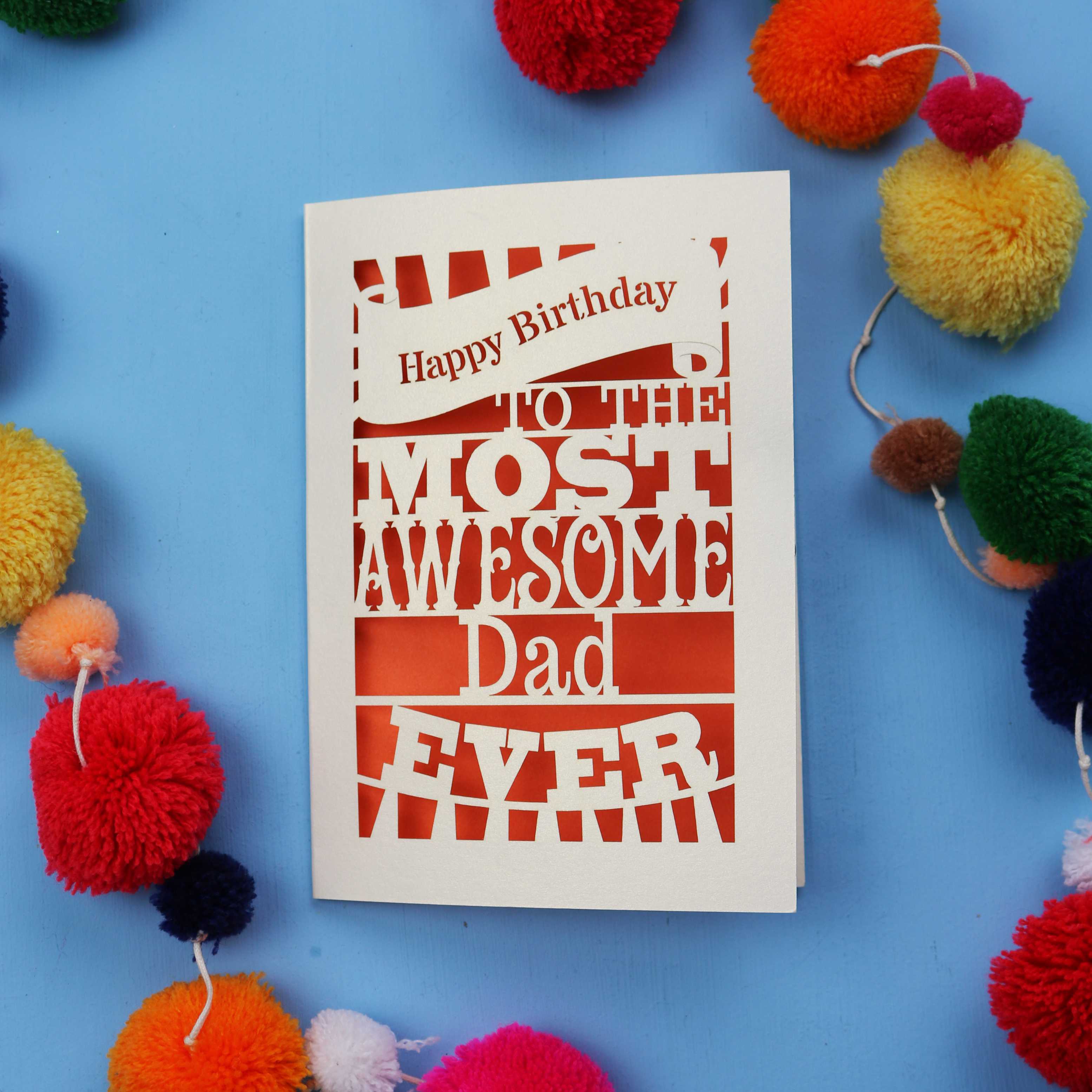 A Dad Birthday card for the most awesome dad ever with colourful pom-poms on a blue background