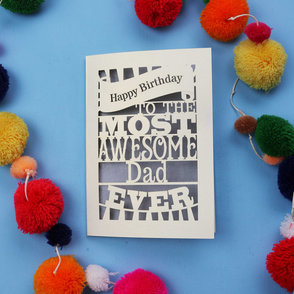 A Dad Birthday card for the most awesome dad ever with colourful pom-poms on a blue background