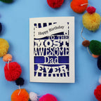 A Dad Birthday card for the most awesome dad ever with colourful pom-poms on a blue background