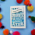 Daddy Birthday card with colourful text on a blue background with pom-poms