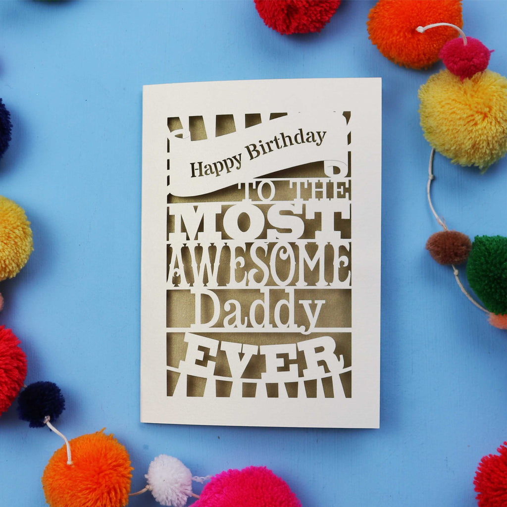 Birthday card for the most awesome daddy ever on a blue background with colourful pom-poms.