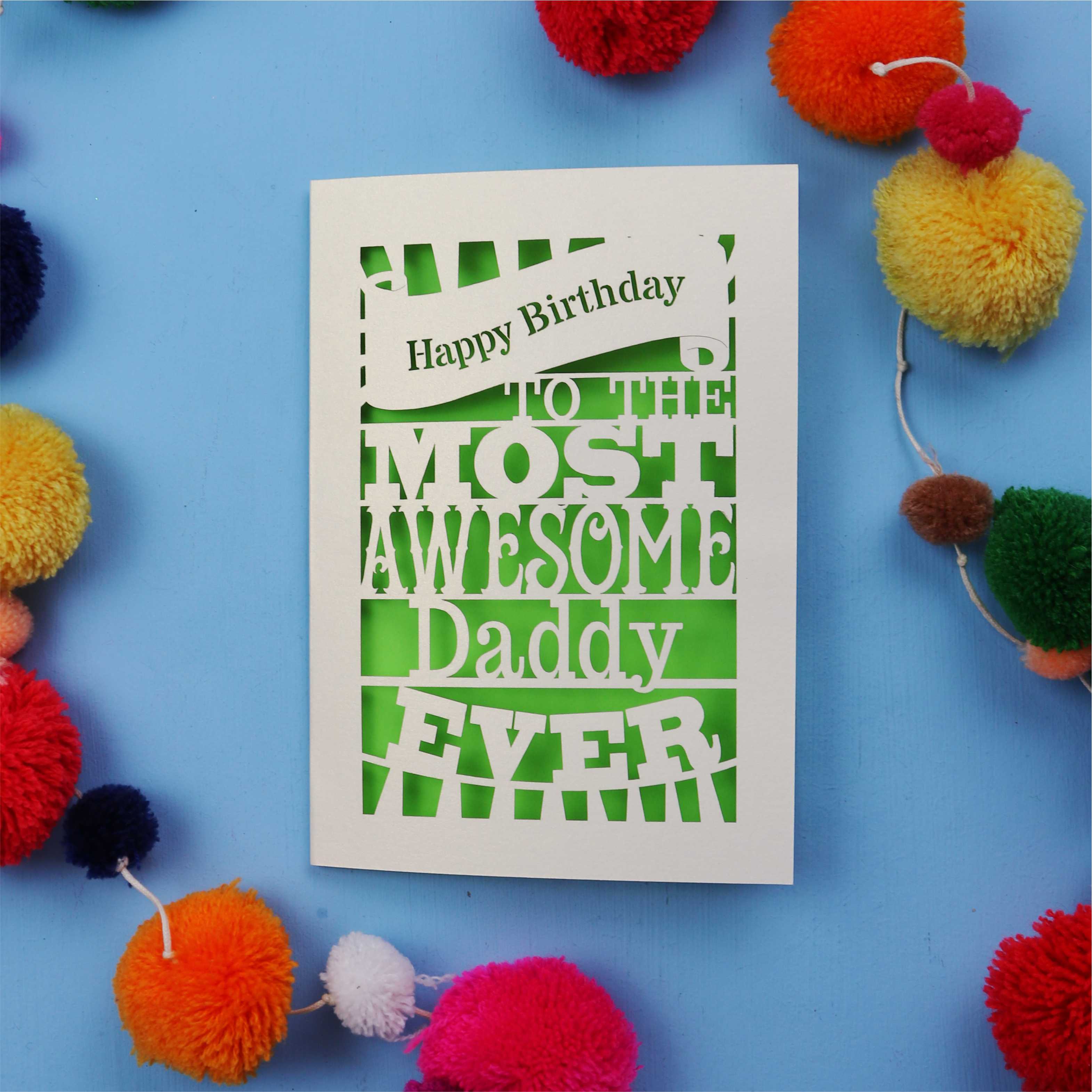 Daddy Birthday card with colourful text on a blue background with pom-poms
