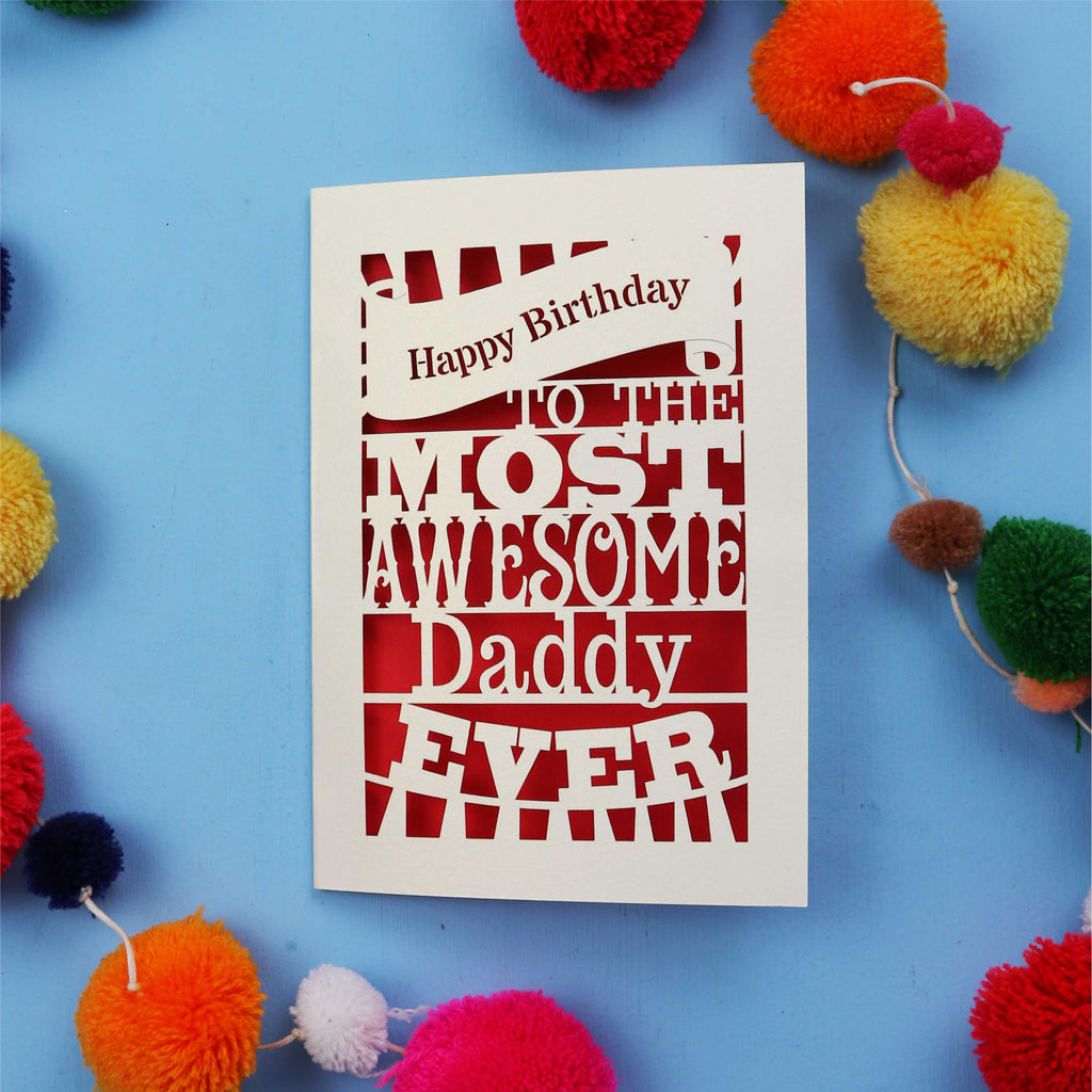 Daddy Birthday card with colourful text on a blue background with pom-poms